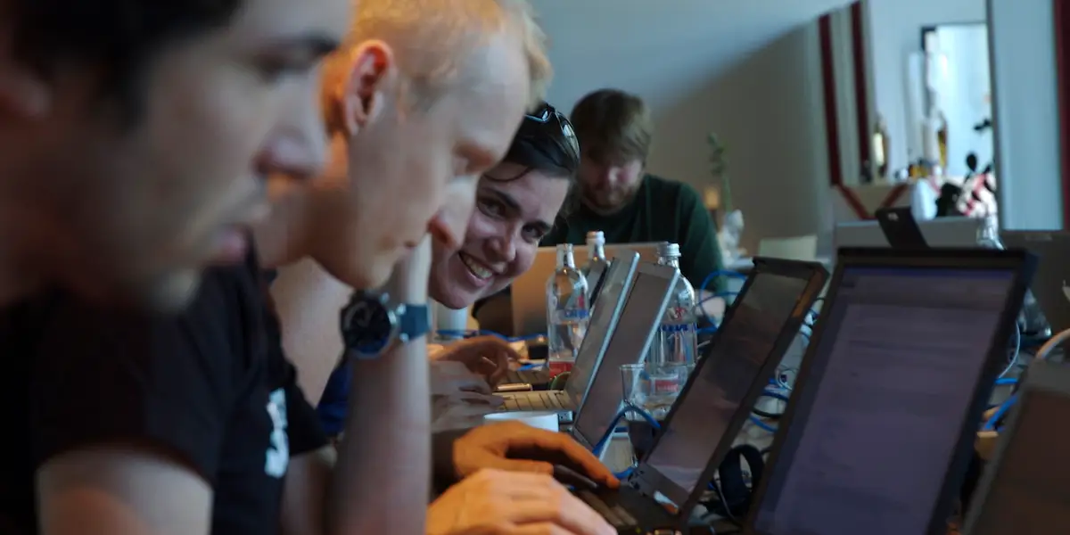 A group of people doing coding in their laptops.